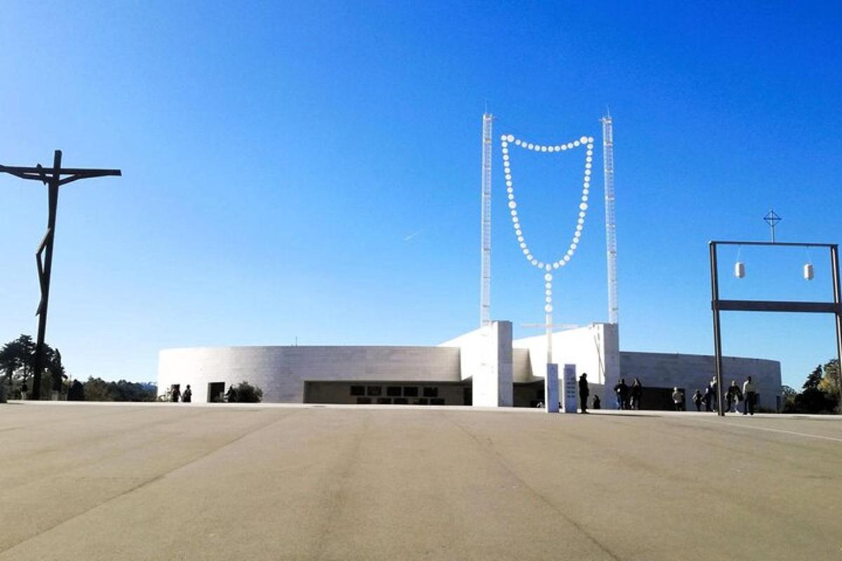 a large white building with a cross in front of it