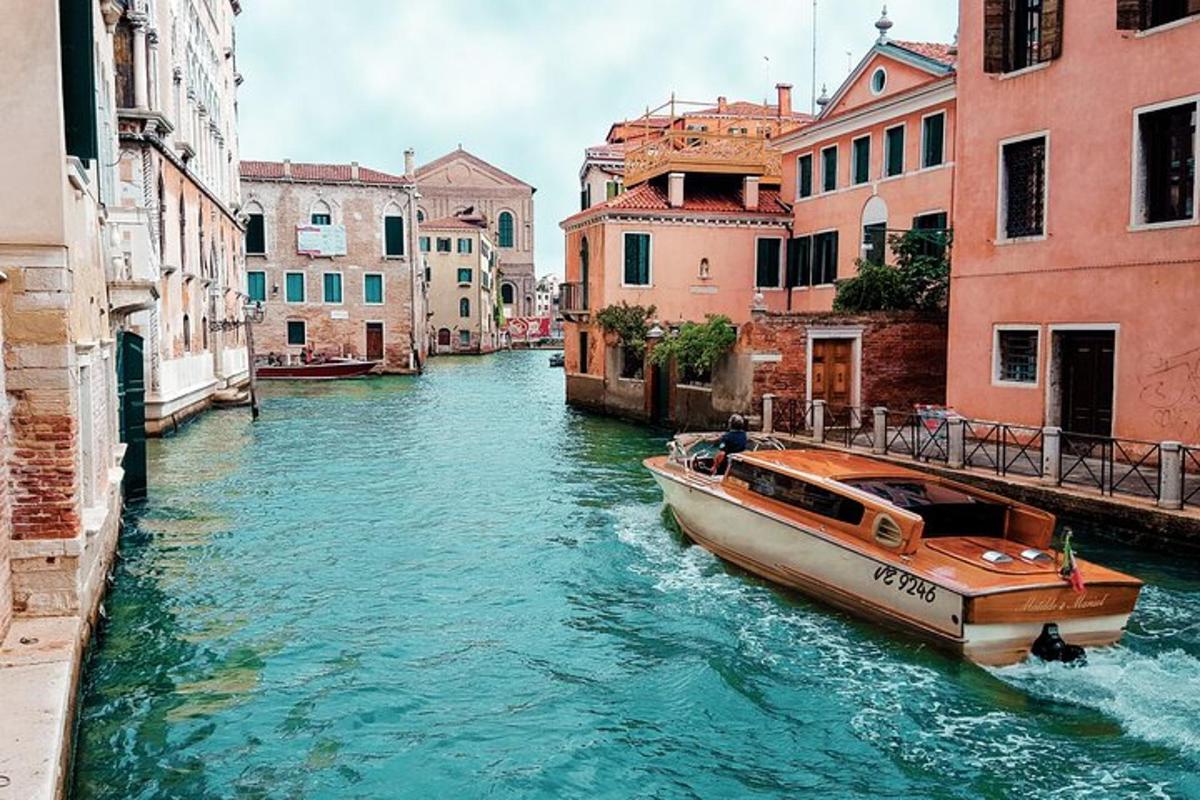 a boat in a canal between two buildings