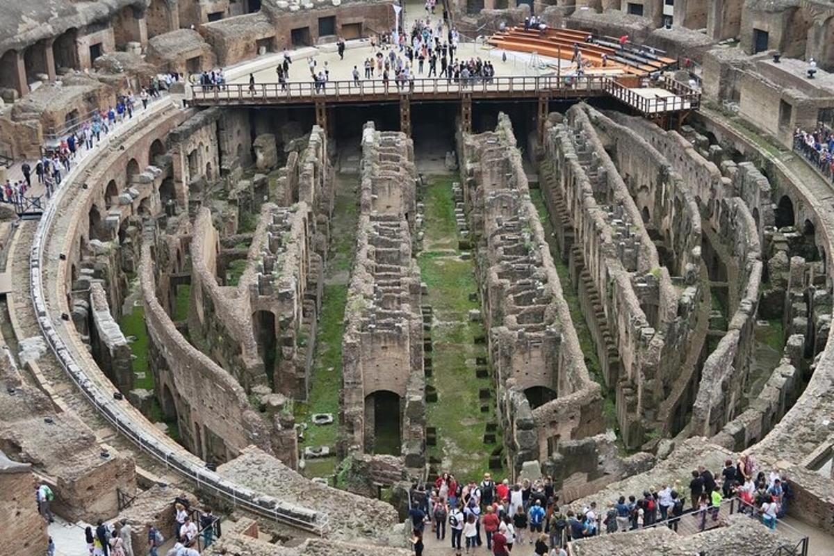 a group of people walking around the coliseum