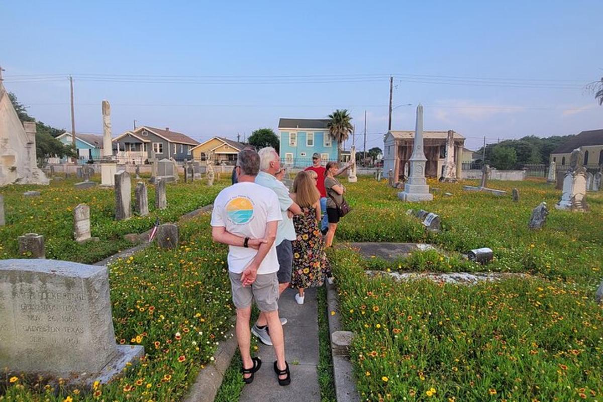 a group of people walking through a cemetery
