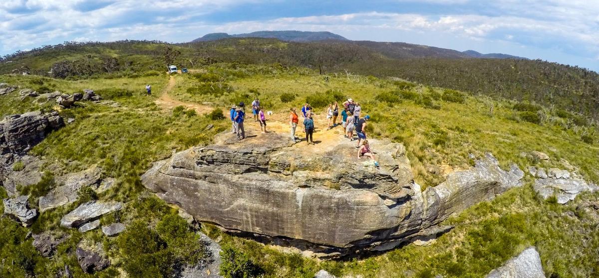 a group of people walking on top of a mountain
