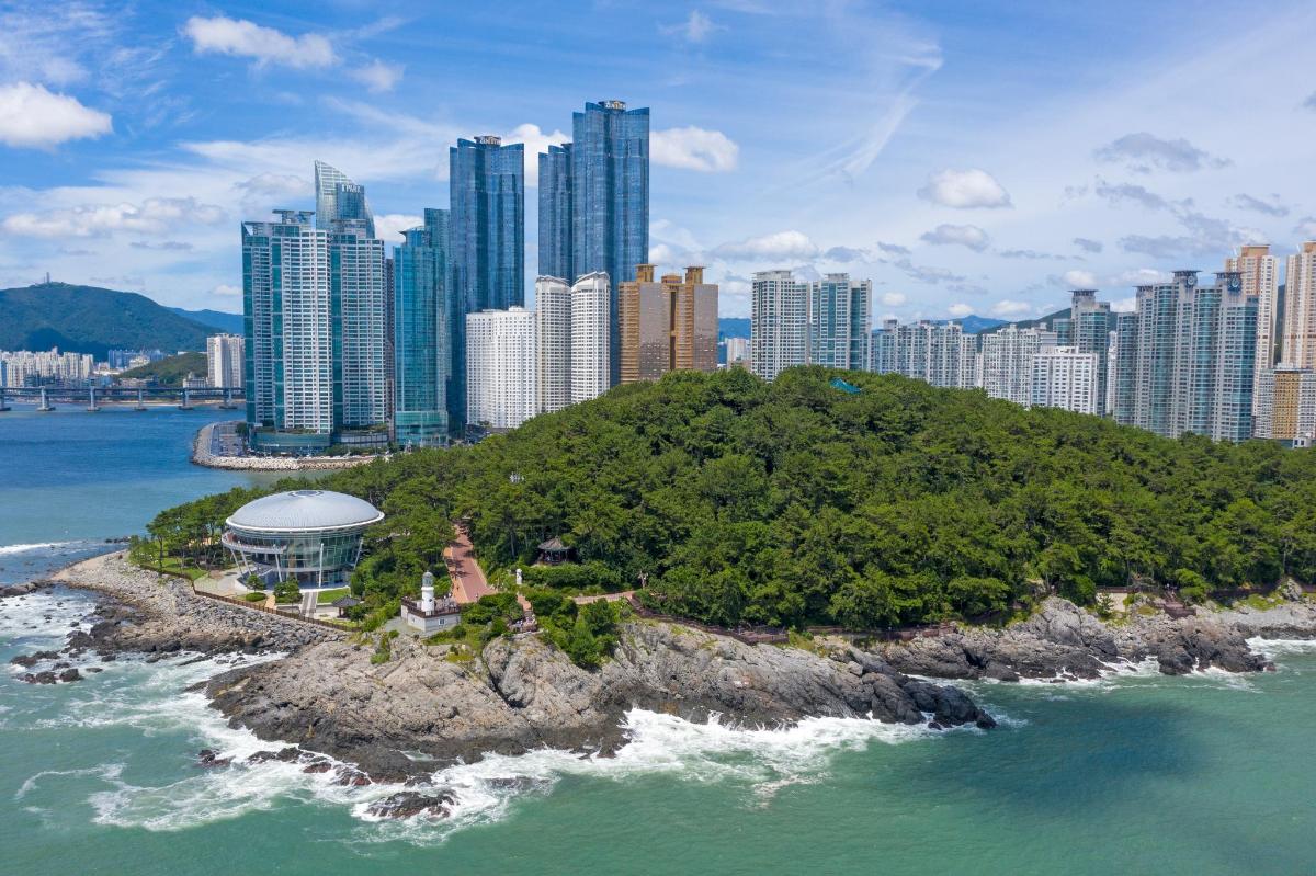 an island in the ocean in front of a city