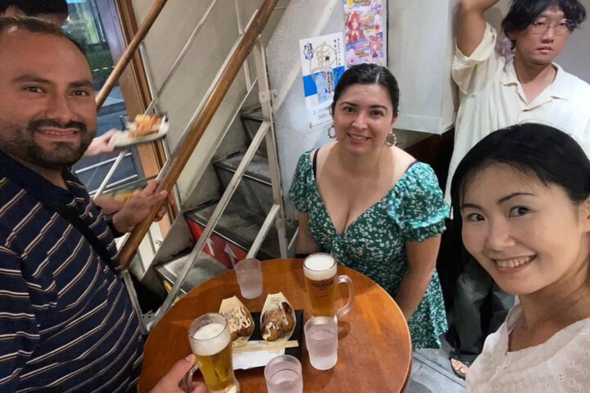a group of people sitting around a table with beers
