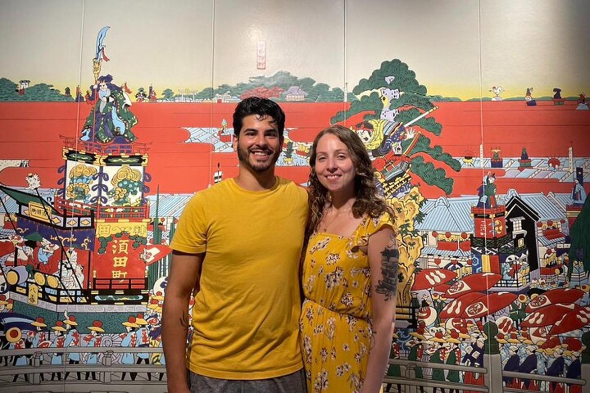 a man and a woman standing in front of a wall