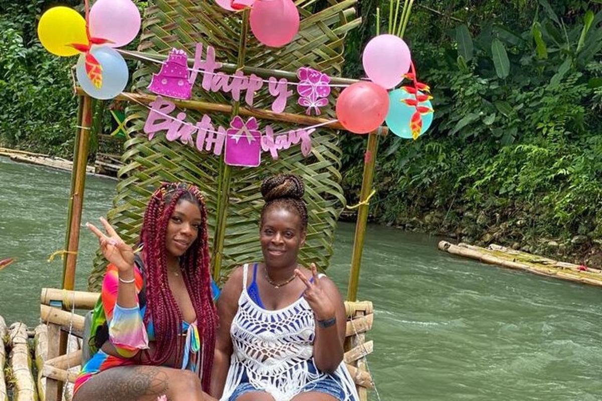 two girls are sitting in a raft with balloons