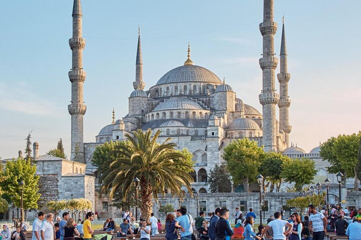 a group of people standing in front of a mosque