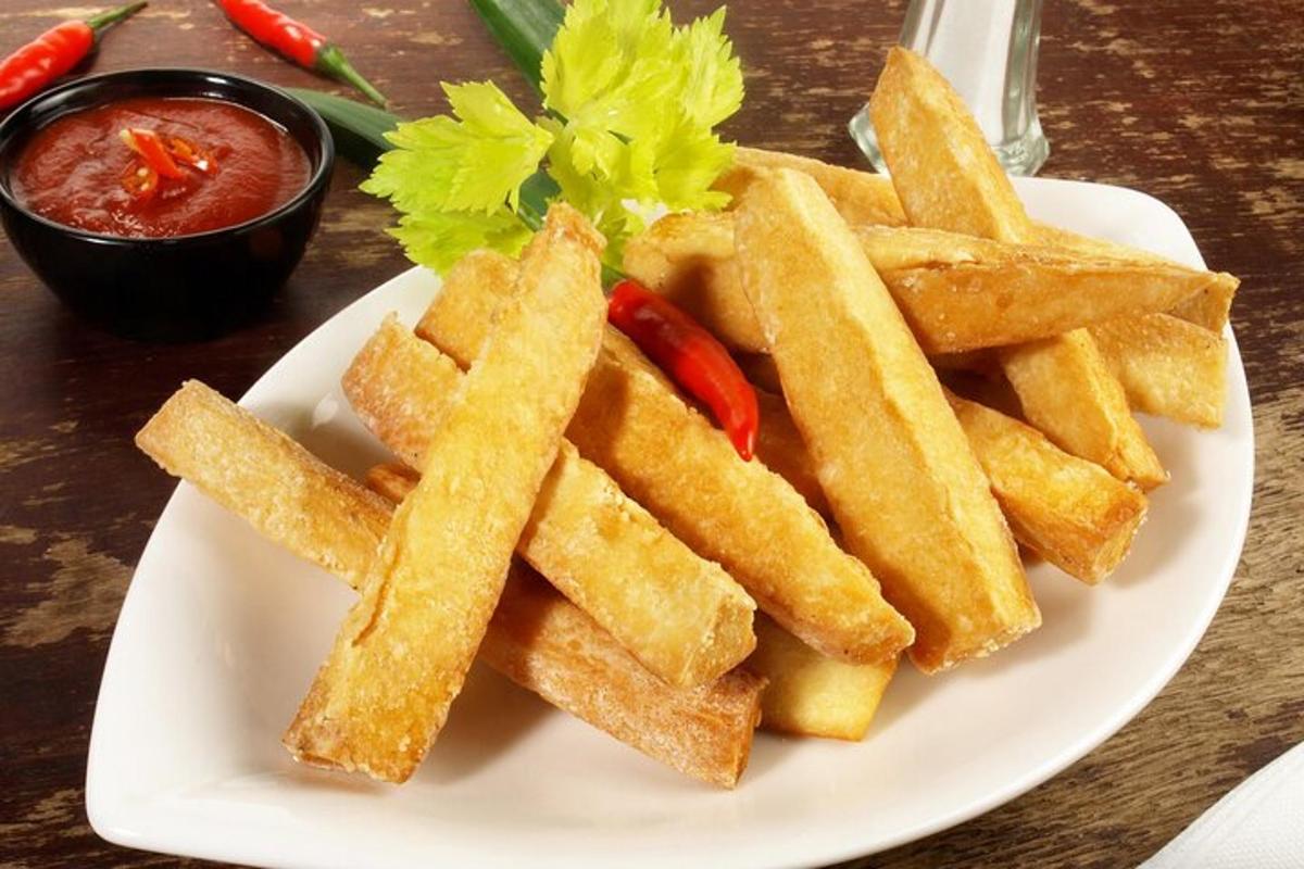 a plate of french fries and salsa on a table