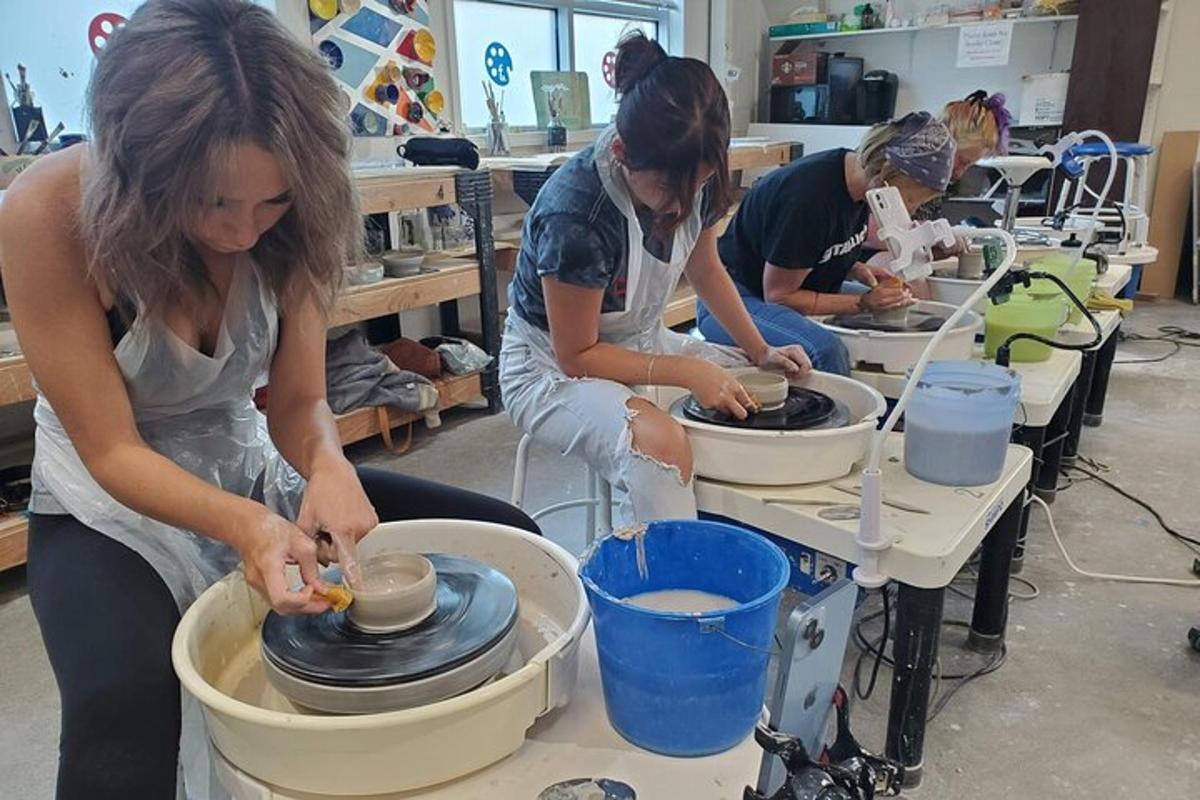un grupo de personas trabajando en un torno de alfarero