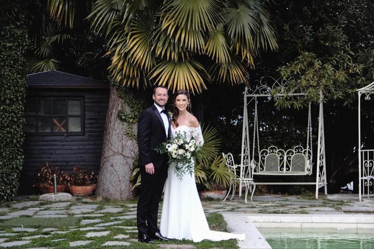 a bride and groom are posing for a picture