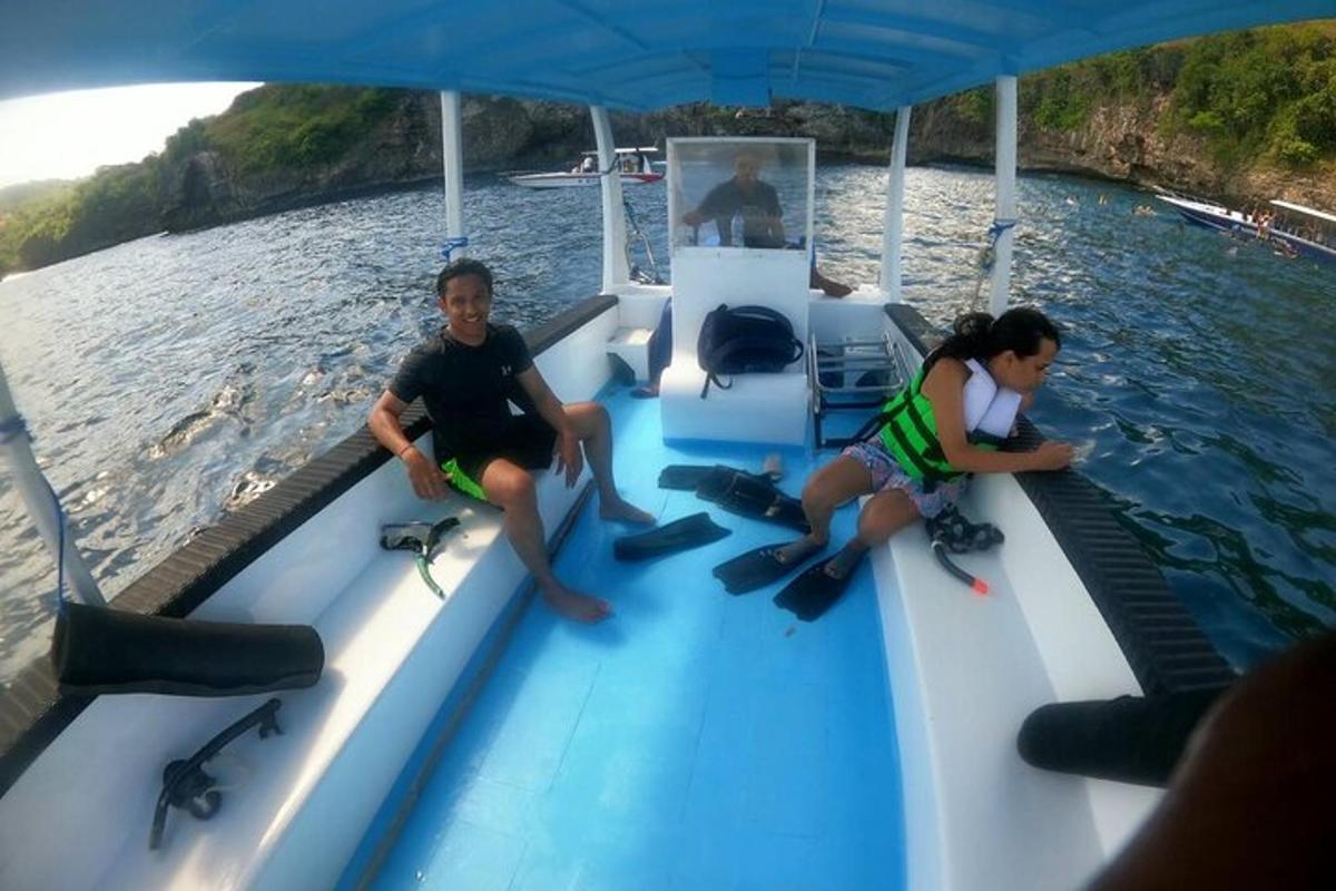 two people sitting on a boat in the water