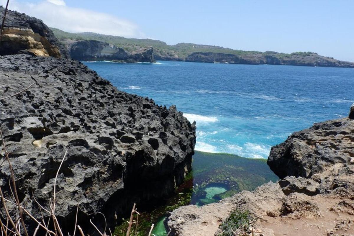 a view of the ocean from a rocky cliff