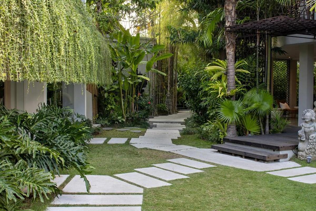 a garden with a stone pathway and plants