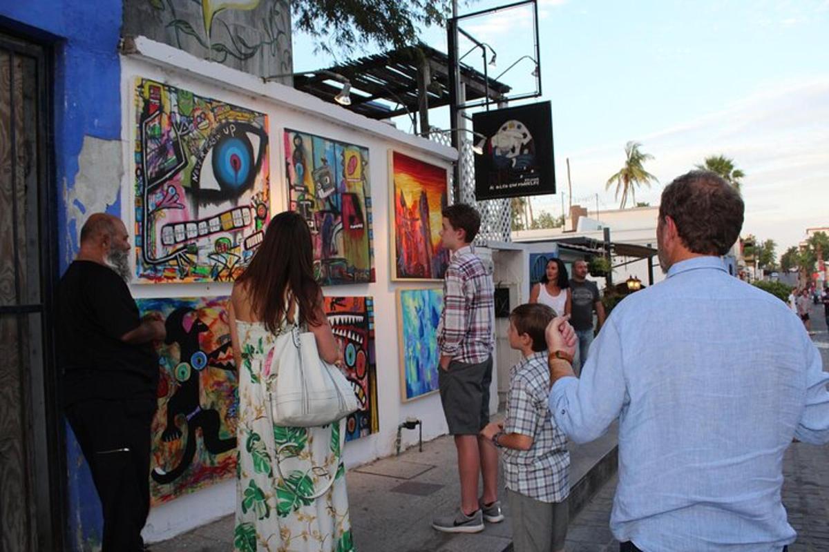 a group of people standing in front of a mural
