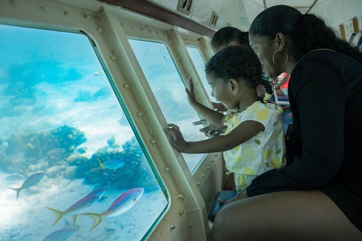 a woman and a little girl looking at an aquarium