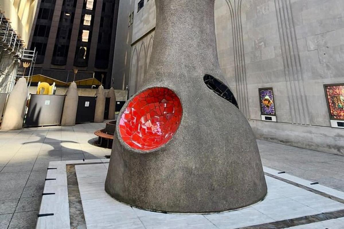 a large sculpture in a building with a red heart