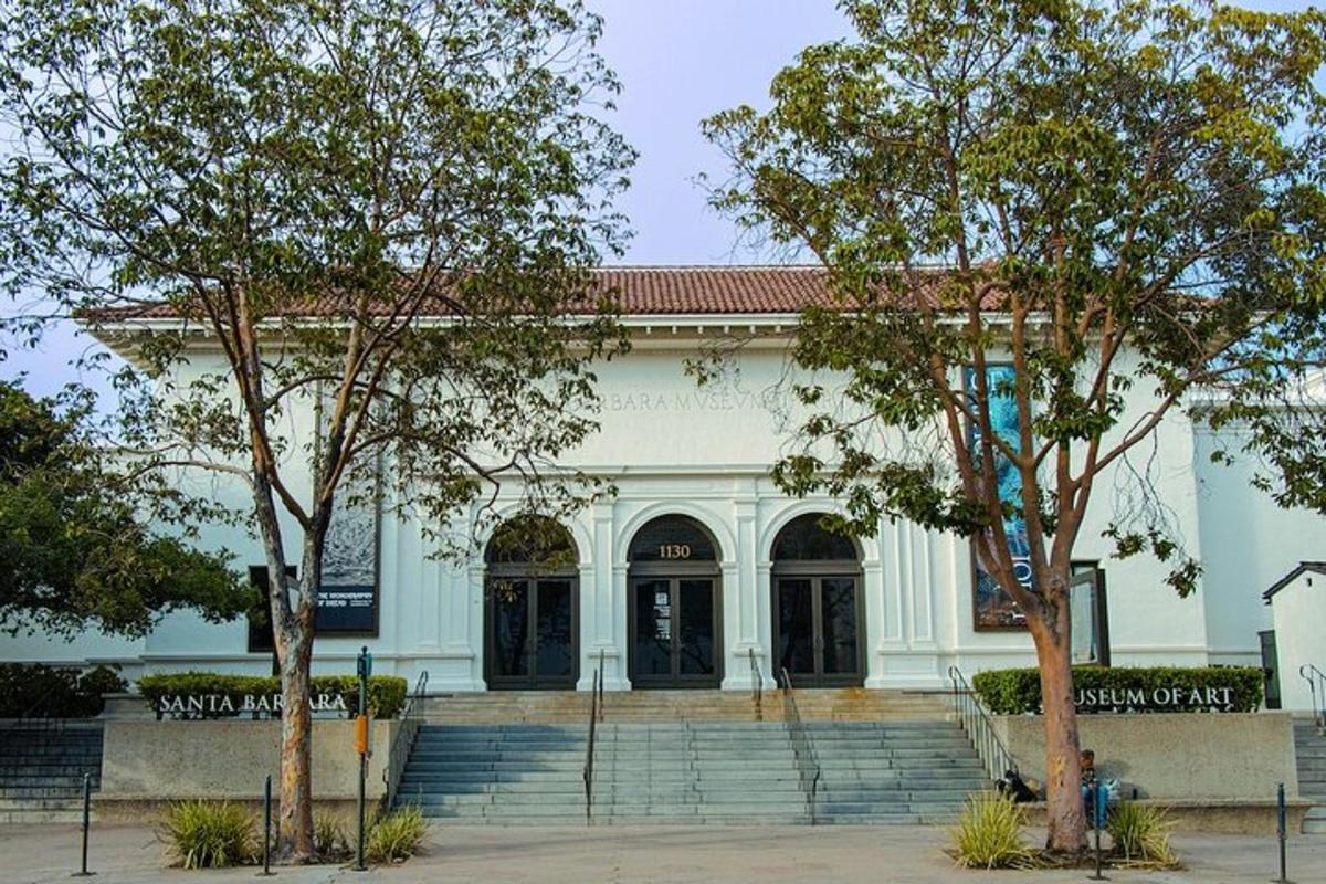 a white building with trees in front of it