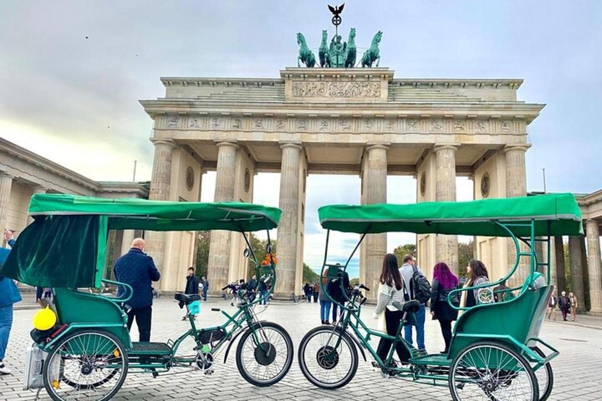 two green bikes parked in front of a building