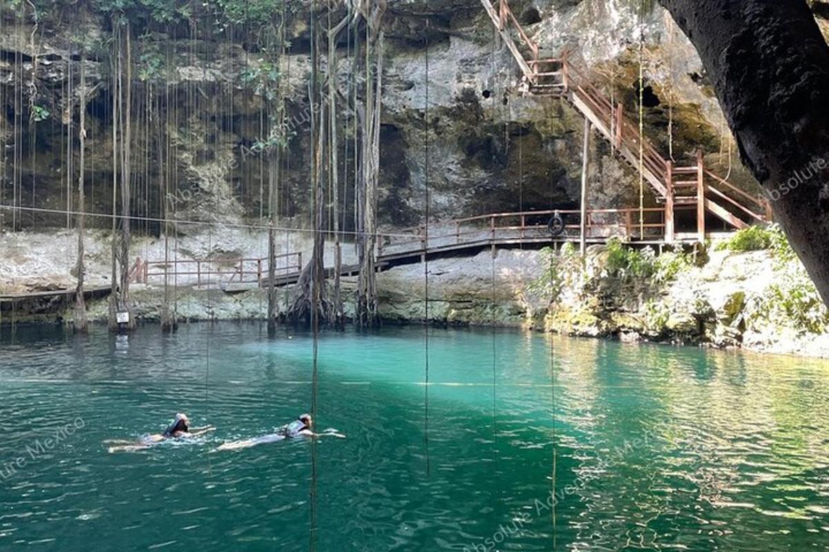 two people in the water in a swing in a river
