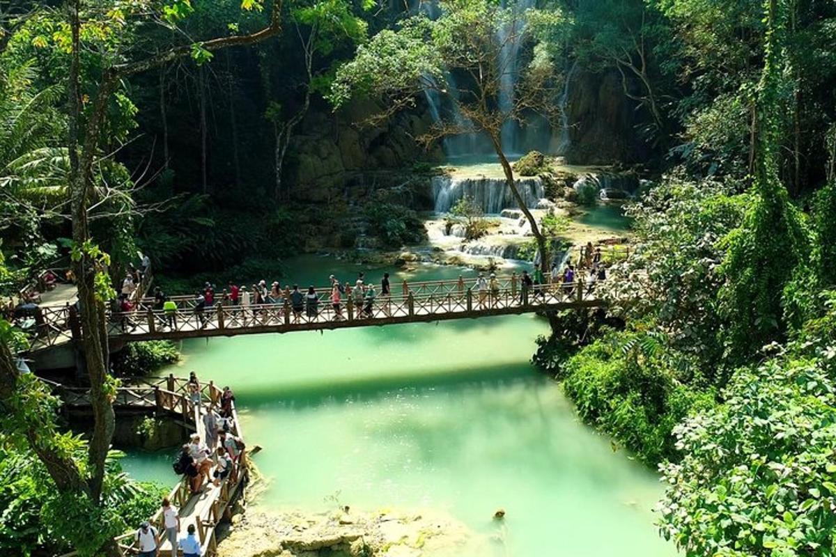 a group of people crossing a bridge over a river
