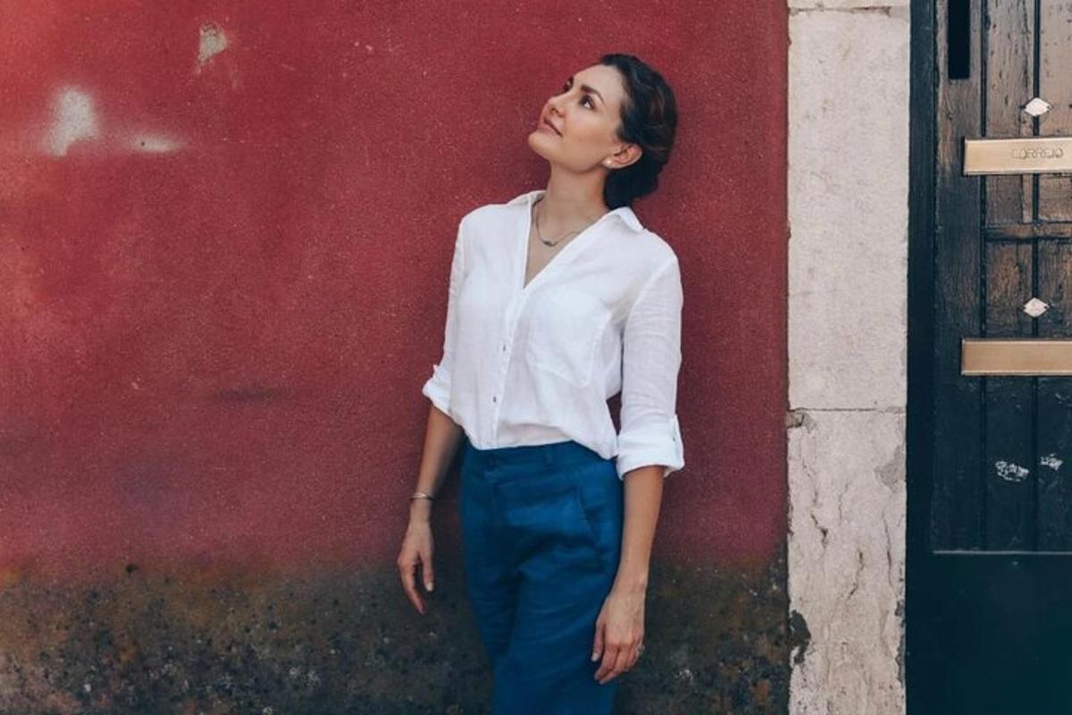 a woman standing in front of a red wall