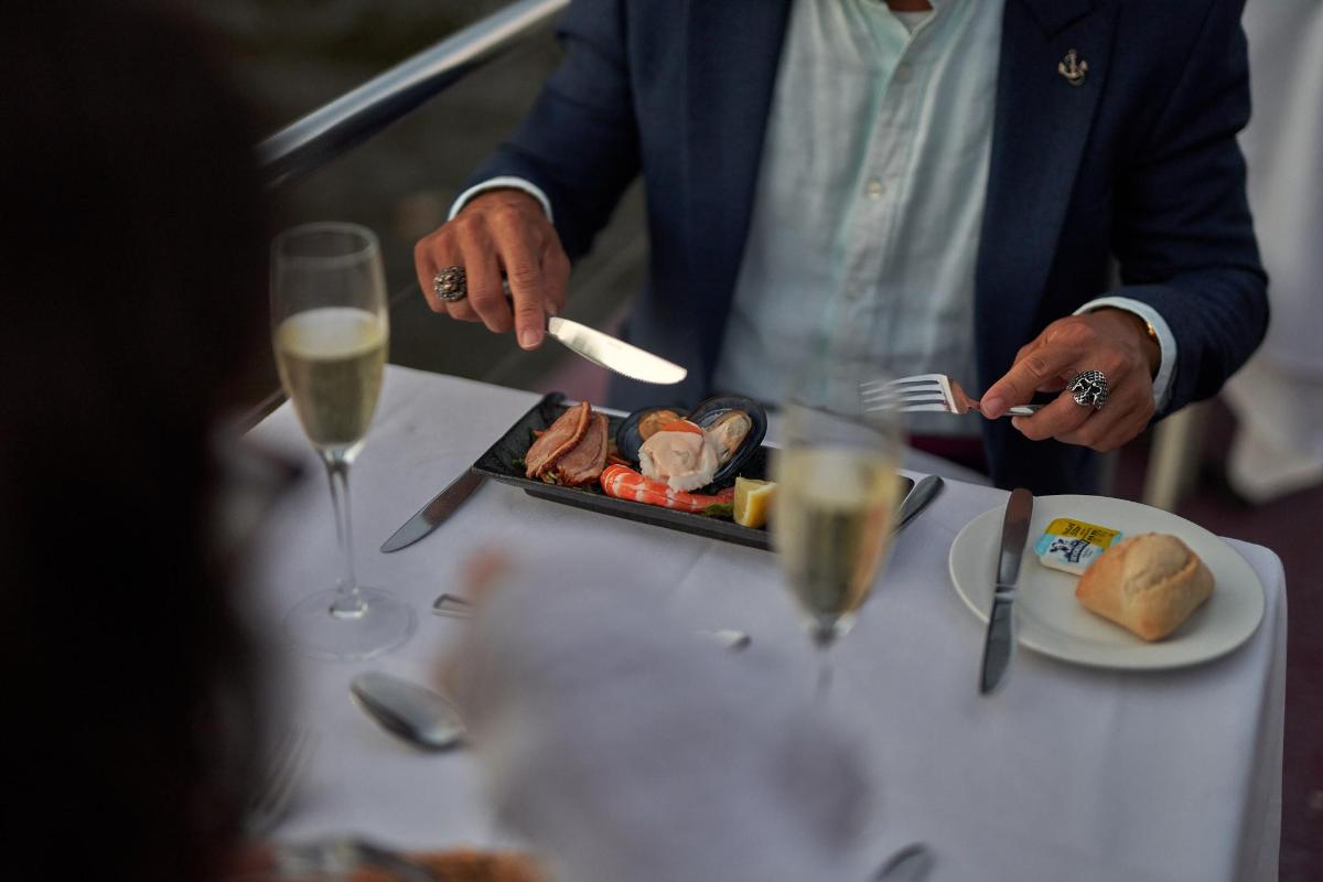 a person sitting at a table with a plate of food