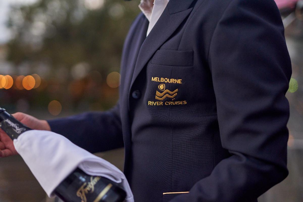 a man in a suit with a melbourne emergency services badge