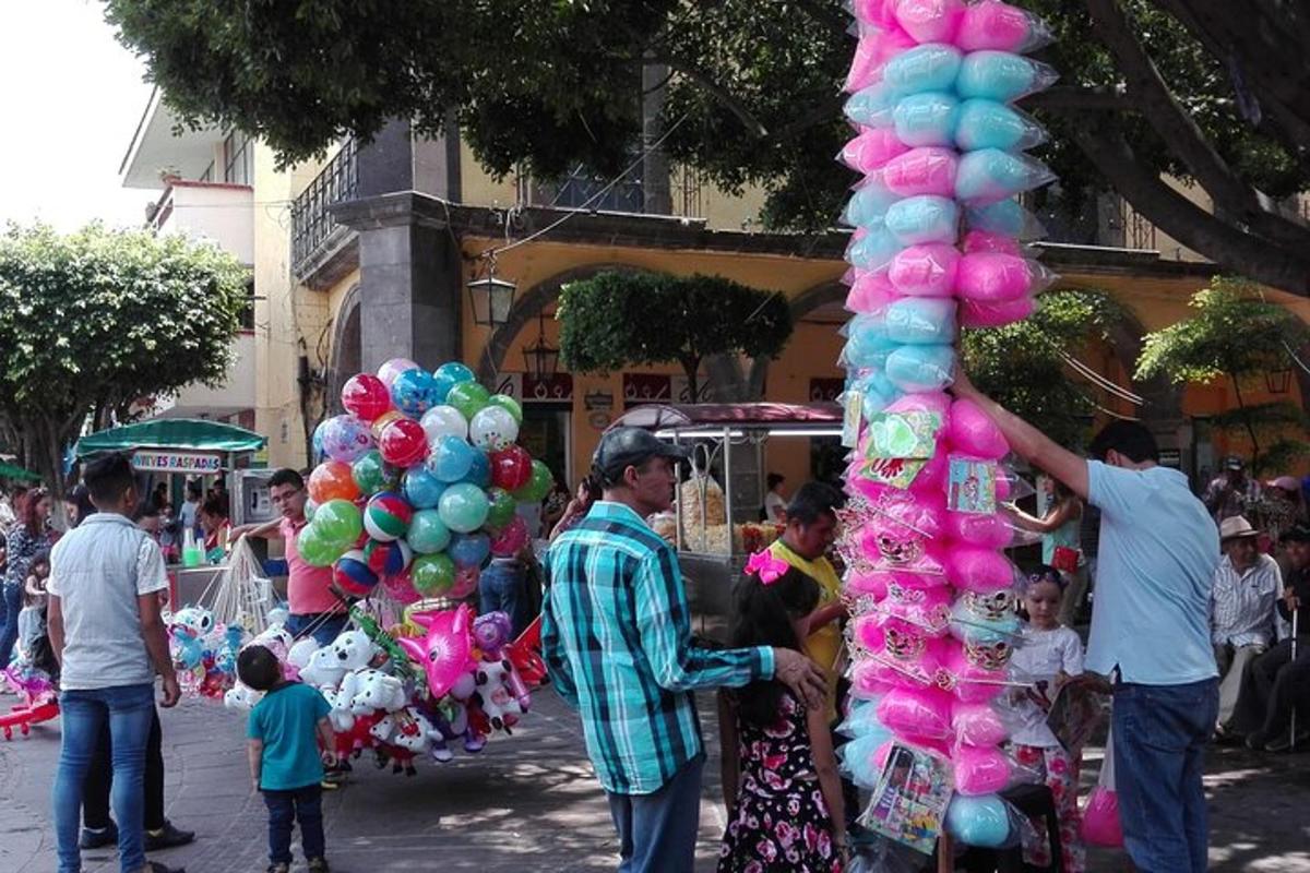 un uomo è in piedi accanto a un mazzo di palloncini
