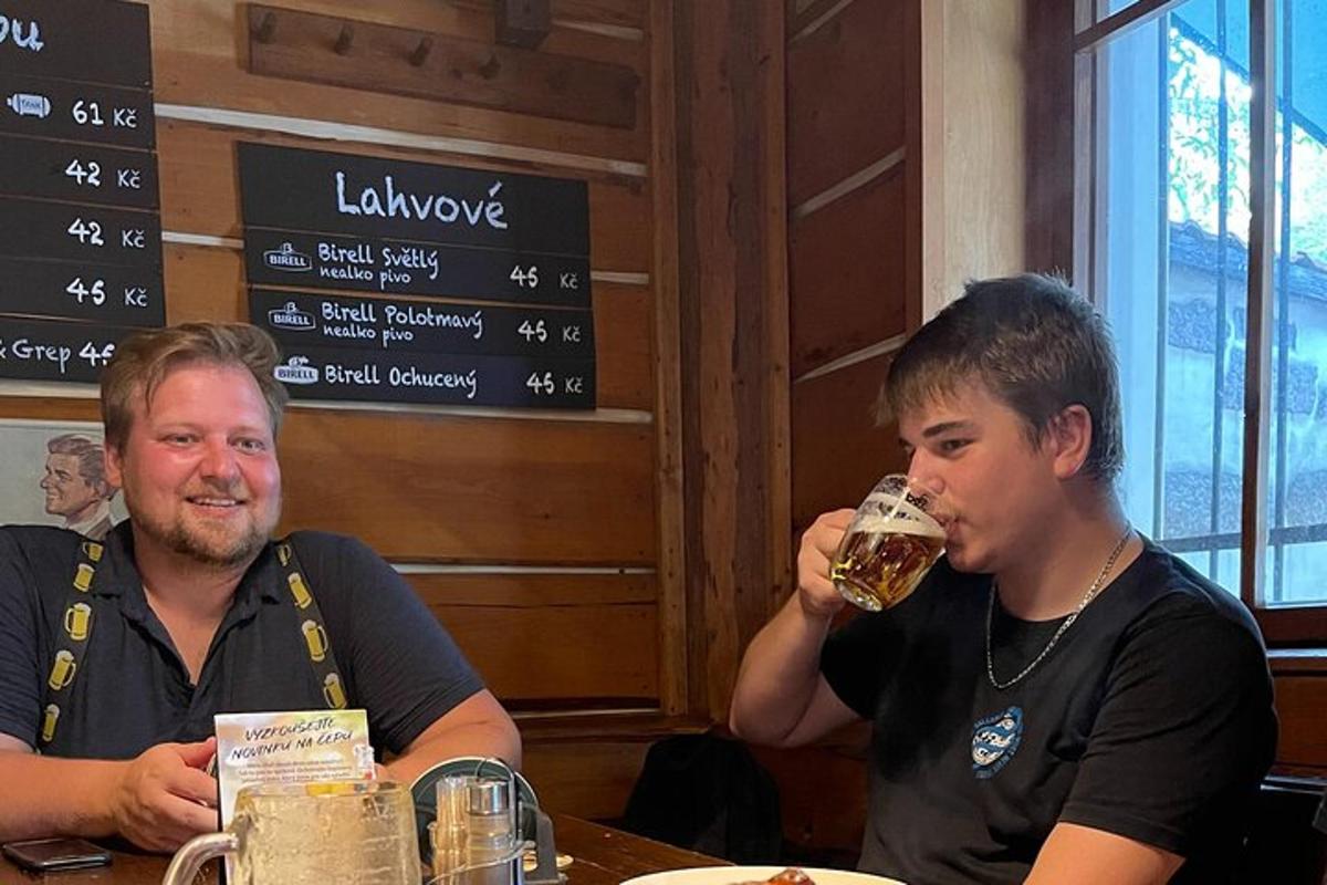 a man and a woman sitting at a table drinking beer