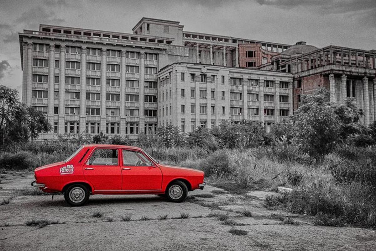 a red car parked in front of a building