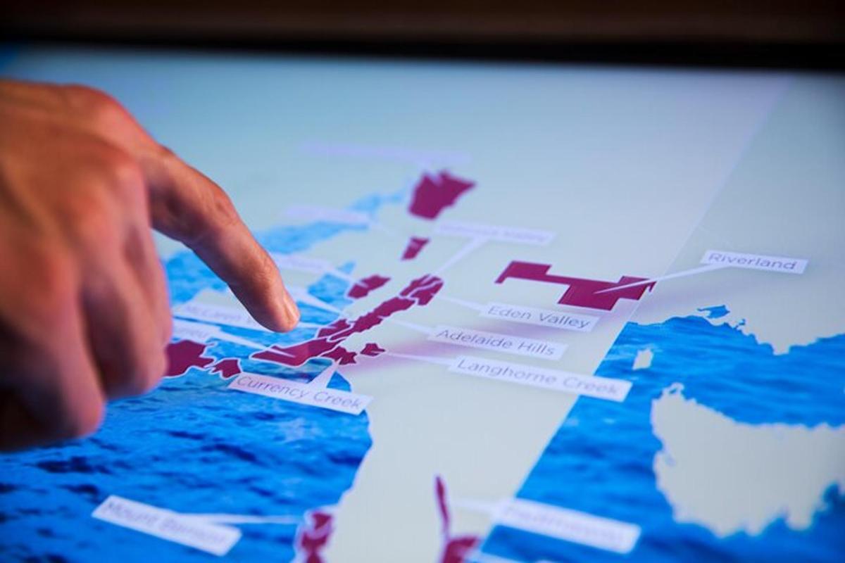 a hand pointing at a map on a computer screen