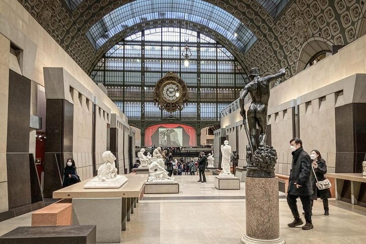 a museum with people looking at statues in a building