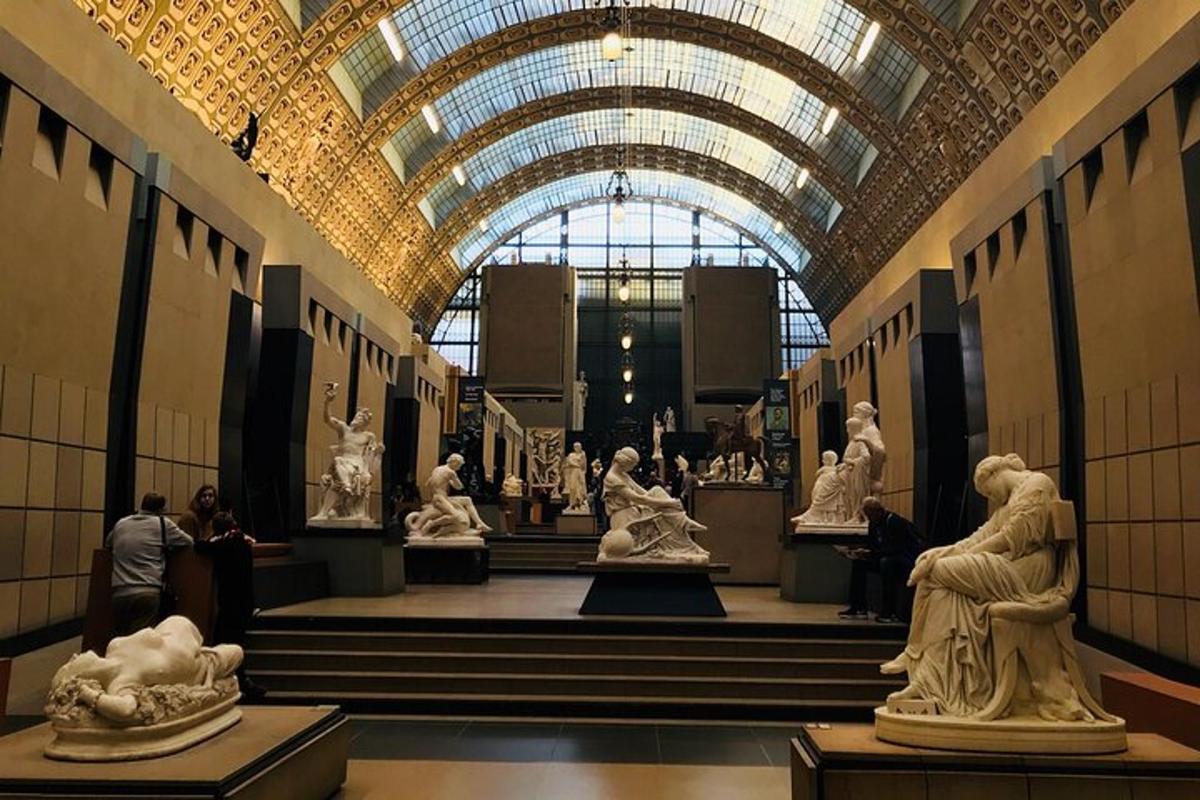 a museum with white statues in a hallway