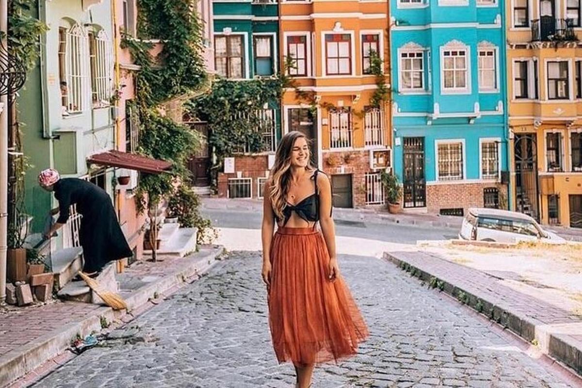 žena v oranžových šatech kráčející po ulici