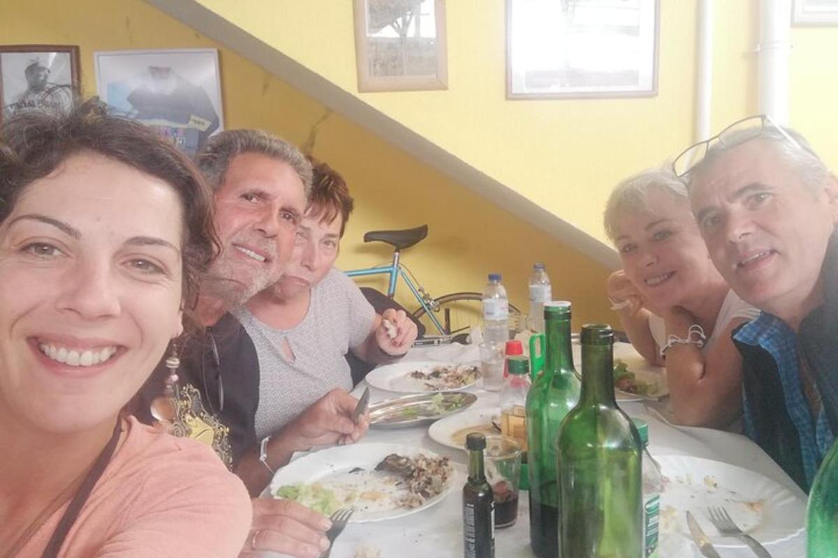 a group of people sitting at a table eating food