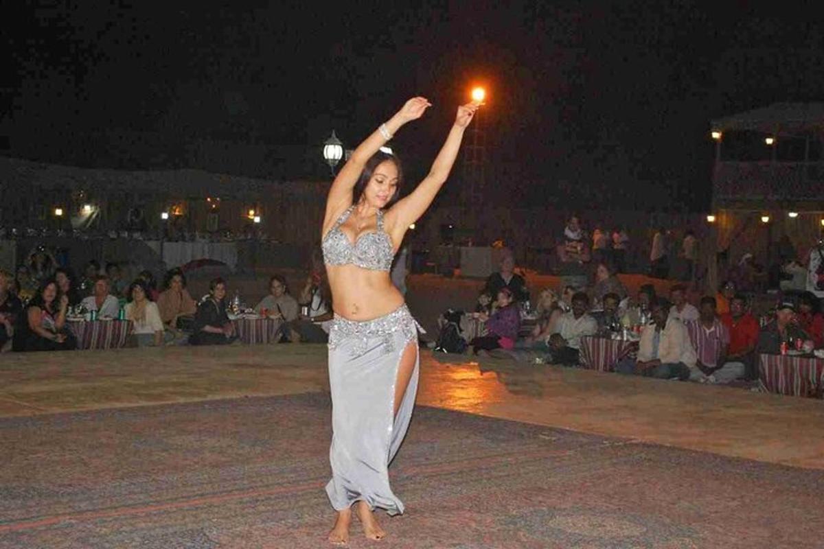 a woman is dancing in front of a crowd