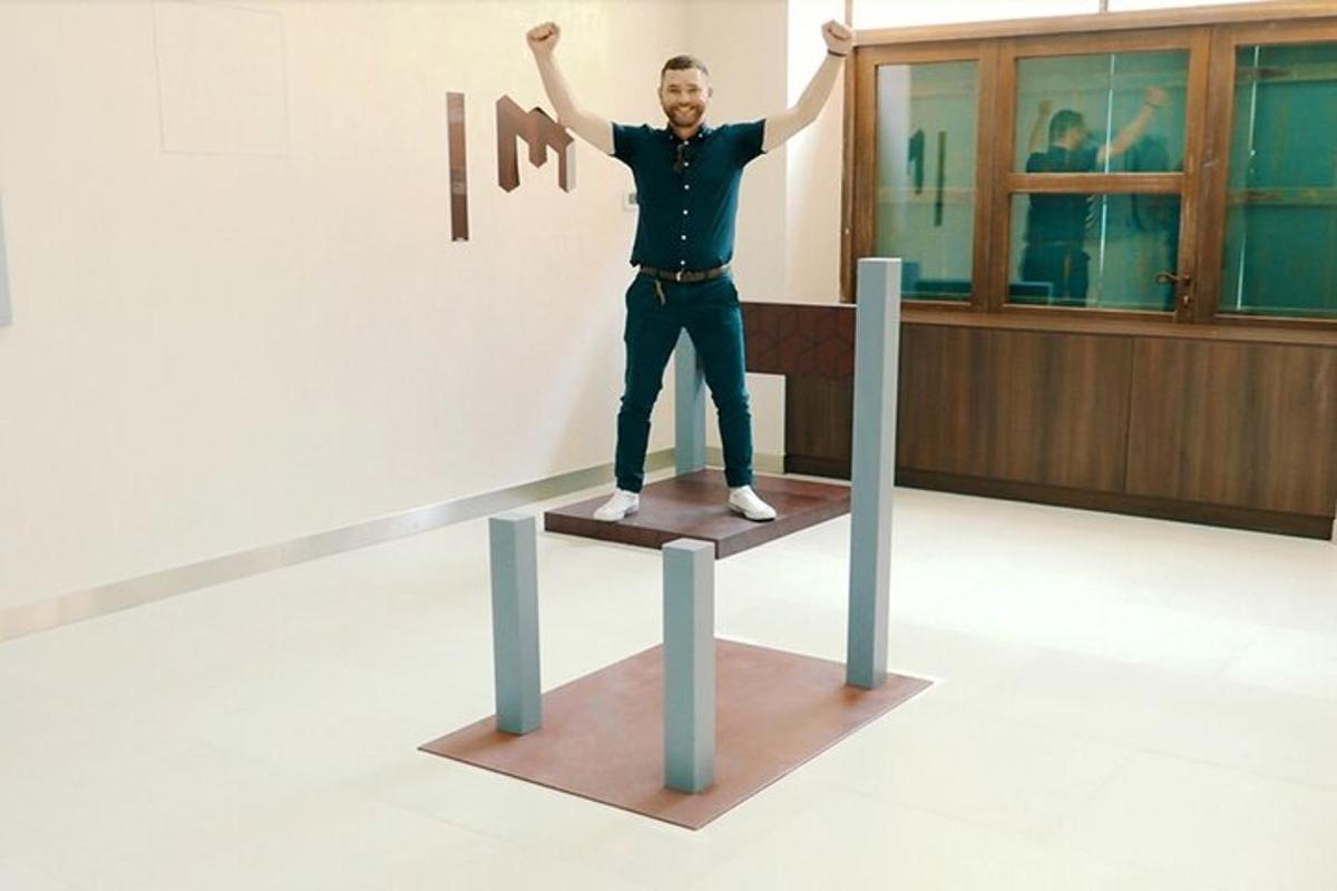 a man standing on a stand with his arms in the air