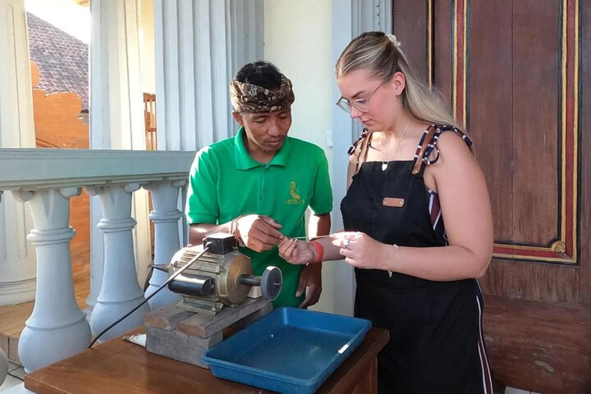 a man and a woman standing next to a sewing machine