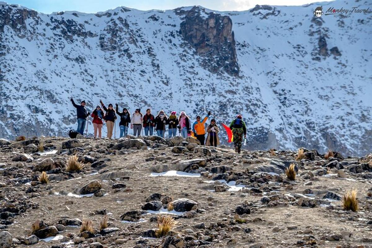 a group of people standing on top of a mountain