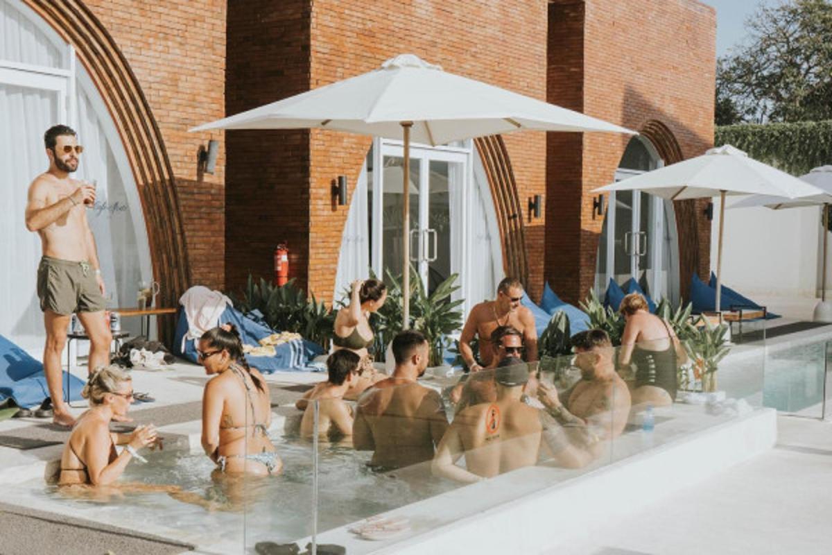 a group of people sitting in a swimming pool
