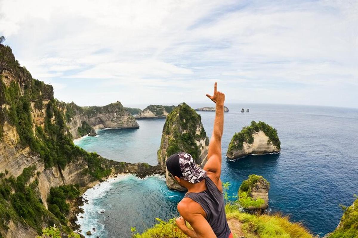 a man standing on a cliff looking at the ocean