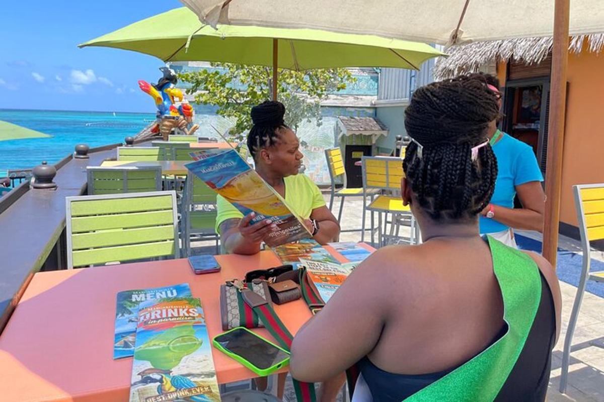 duas mulheres sentadas à mesa na praia
