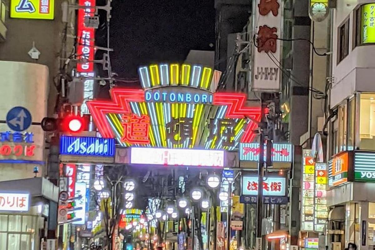 a busy city street at night with neon signs