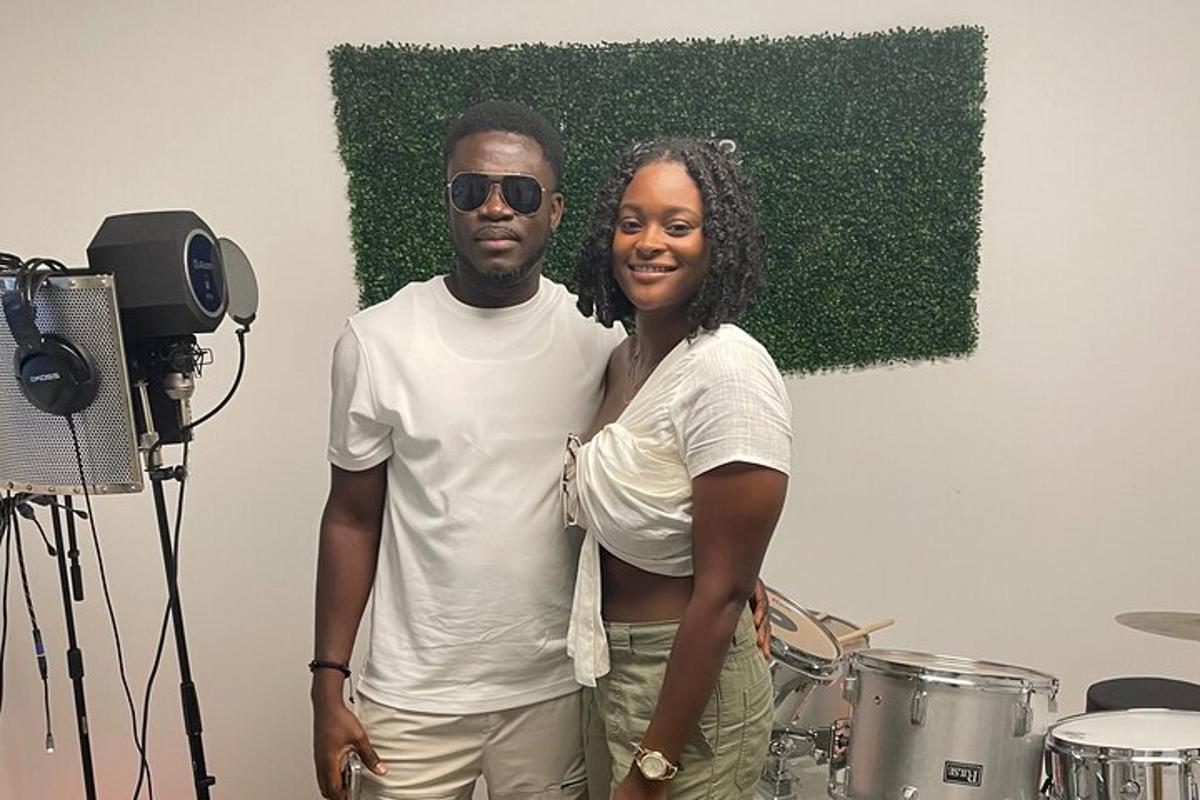 a man and a woman standing next to drums