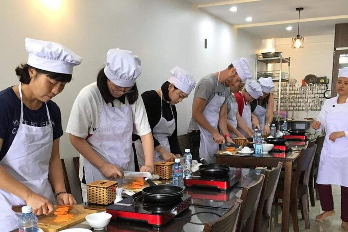 un grup de persones a la cuina preparant menjar