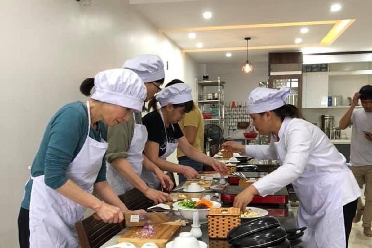 un grup de oameni într-o bucătărie care pregătesc mâncare