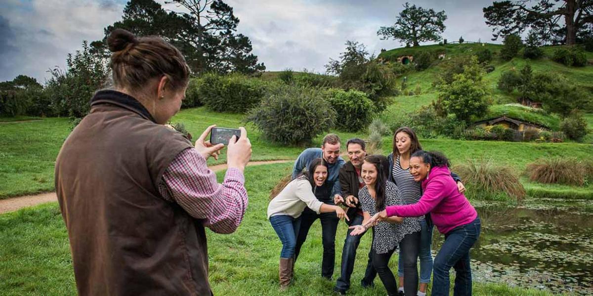 a woman taking a picture of a group of people