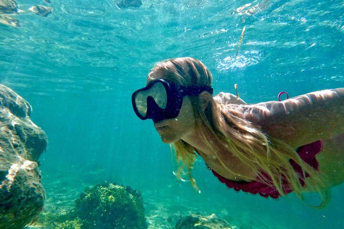 a woman in the water with goggles on