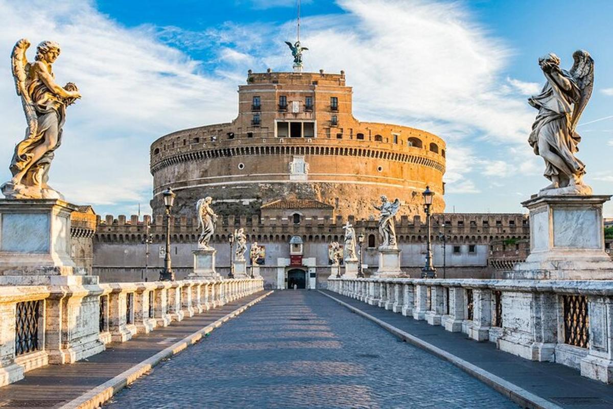 a large building with statues on a bridge
