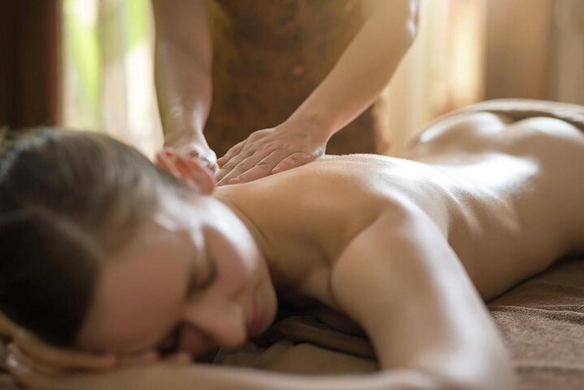 a woman getting a back massage on a bed