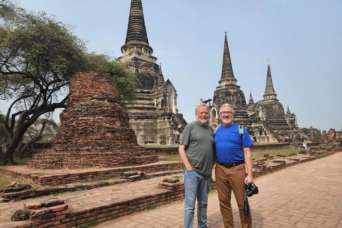 two men standing in front of a temple